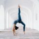 woman in blue leggings and black tank top doing yoga